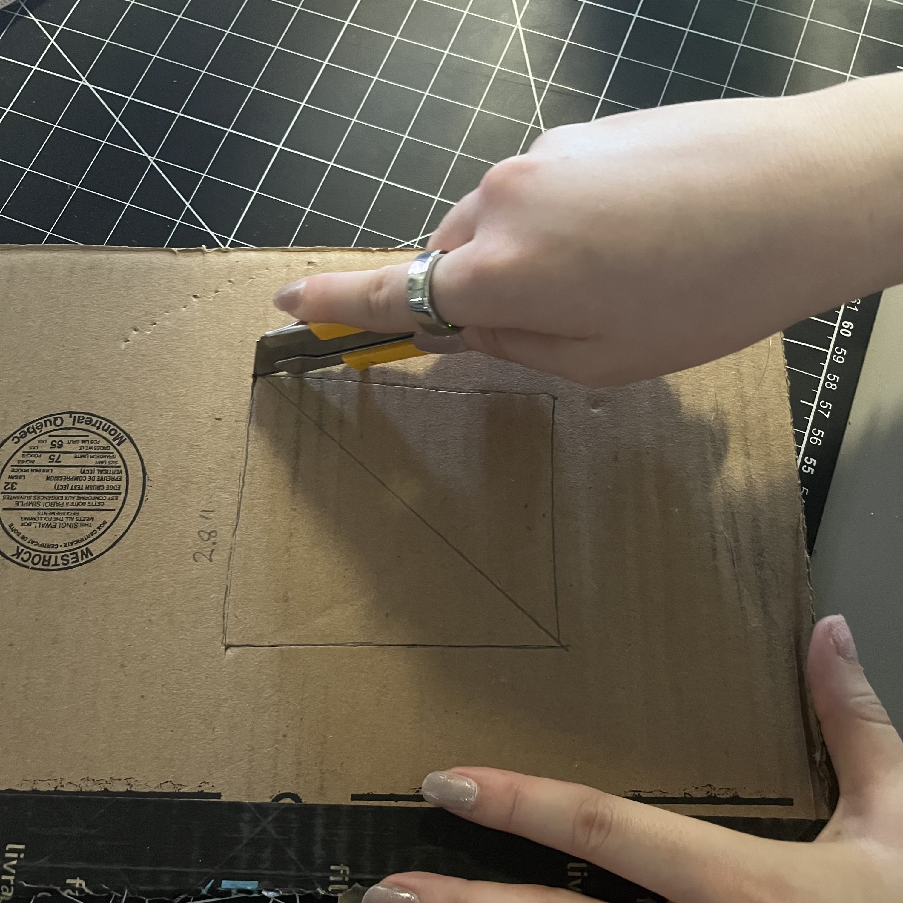 We started cutting the cardboard pieces we needed to make the phone stand.